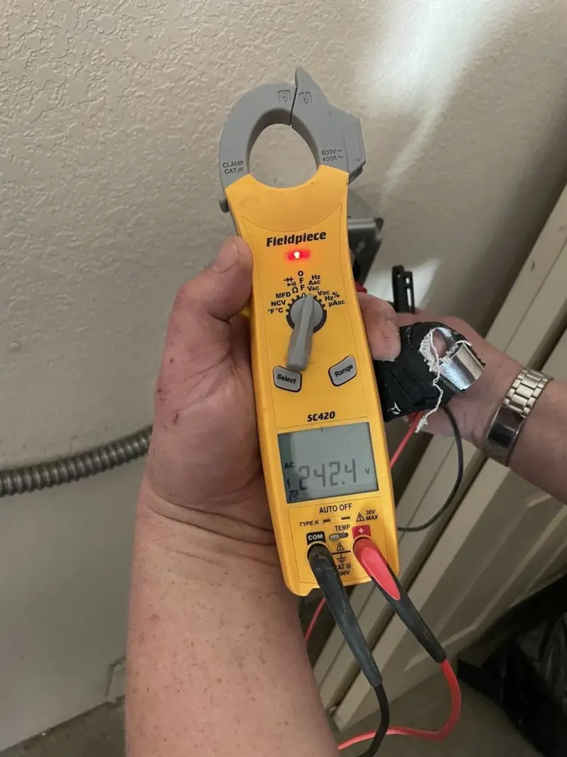 Voltage testing with clamp meter during Outlet Installation in Karnes City